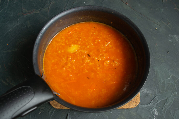 Fully Cooked Lentils Cooked red lentil soup simmering gently in a pot.