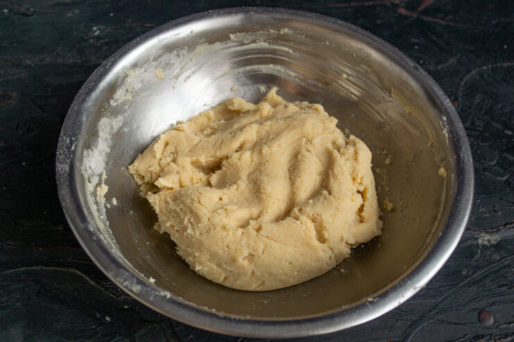 Finished cookie dough A ball of shortbread dough in a metal bowl.