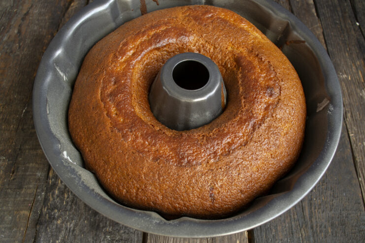 Baked Coconut Cake Golden brown baked cake resting in a bundt pan