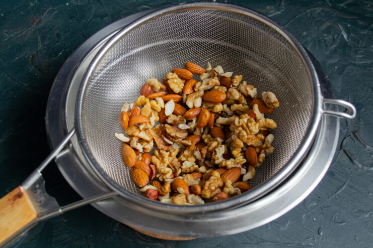 Prepping the nuts Walnuts and almonds sitting in a sieve