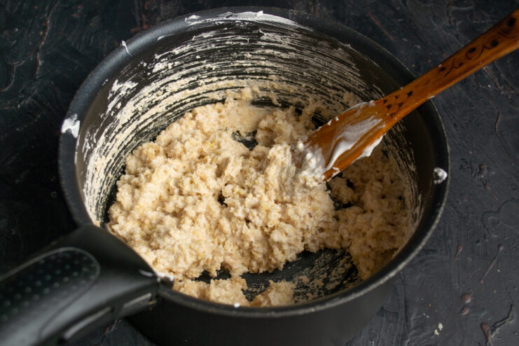 Thick golden cookie dough gathered in a saucepan
