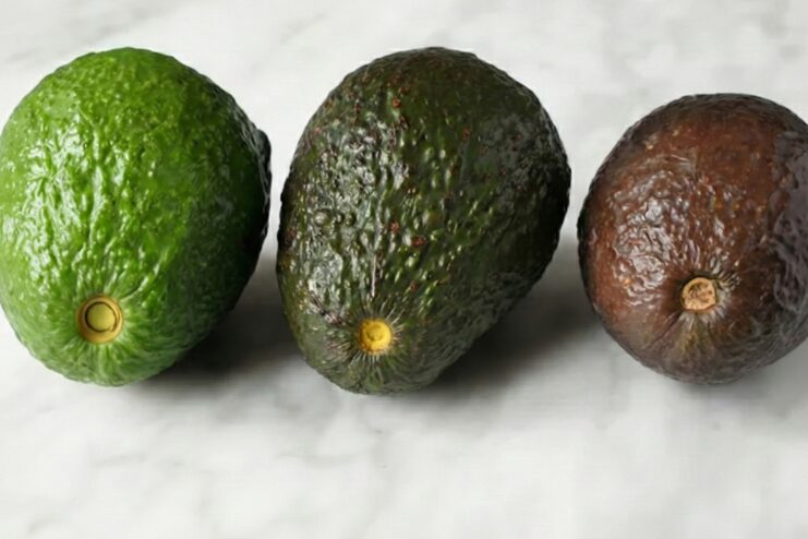 Avocado Stem Color Test Close-up of an avocado with its stem removed revealing a yellow-green patch indicating ripeness