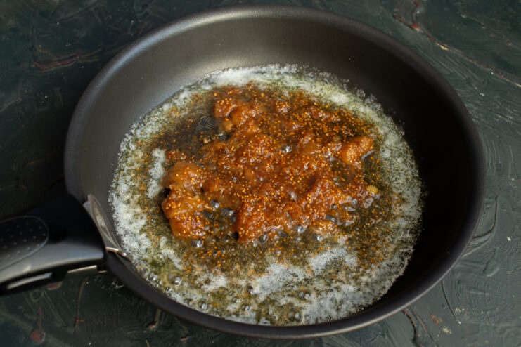 Fig puree and butter cooking in a frying pan.