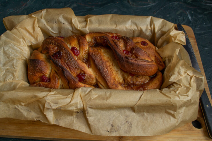 Freshly baked babka Golden brown baked babka loaf cooling inside a rectangular pan