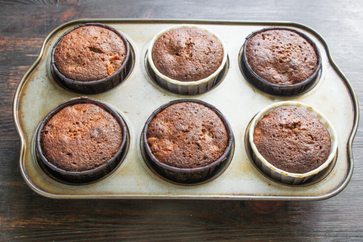 Freshly Baked Cupcakes Freshly baked chocolate cupcakes resting in a muffin tin