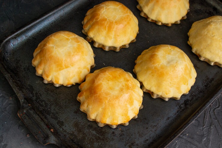 Freshly Baked Tartlet Shells Baked golden shortbread tartlet shells on a baking tray