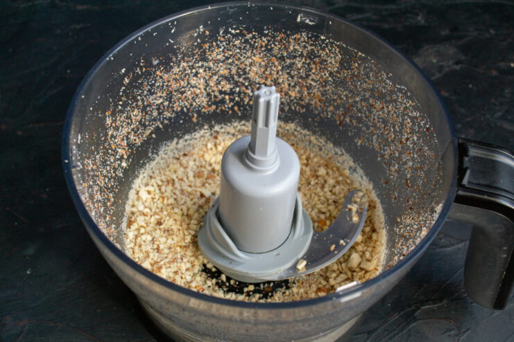 Crushing the Almonds Coarsely crushed almonds in a food processor bowl