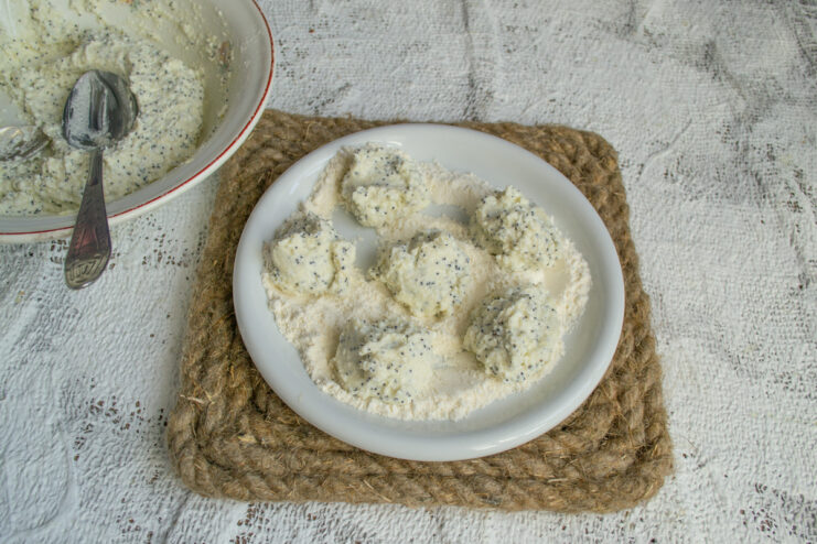 Portioning the dough Small spoonfuls of dough on a flour-dusted plate