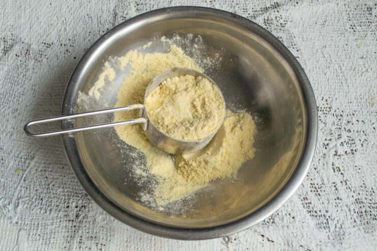 Measuring the Cornmeal Yellow cornmeal measured out in a mixing bowl.