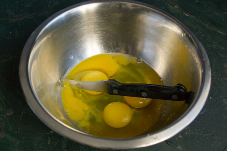 Raw eggs in a mixing bowl for crepe batter.
