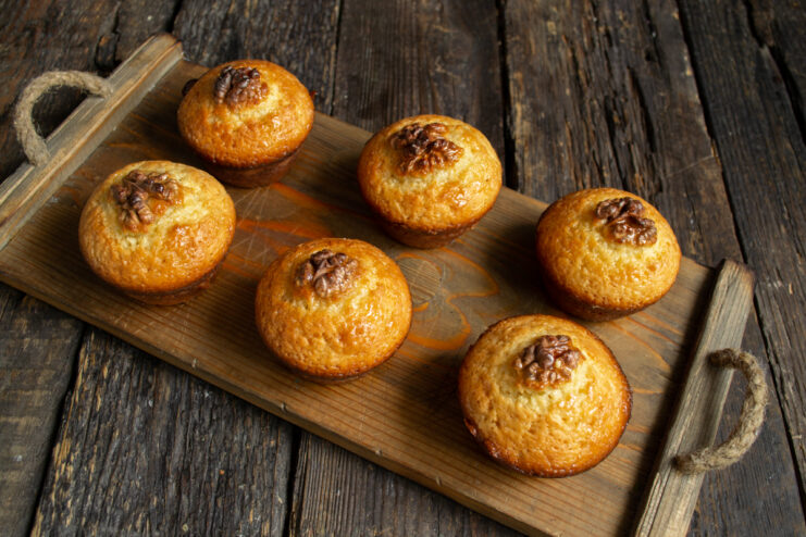 Serving the finished muffins Plated whole wheat lemon muffins served on a wooden tray