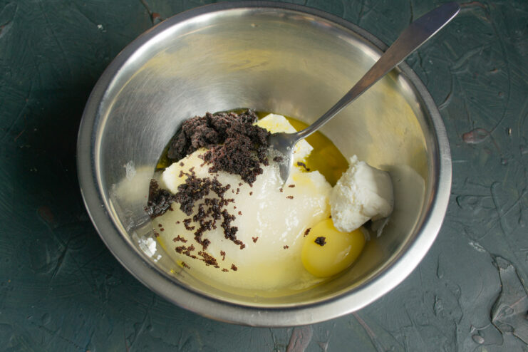 Poppy seeds and melted butter added to the mixing bowl.