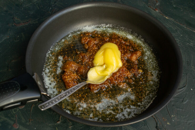 Adding honey to the fig sauce in a skillet.
