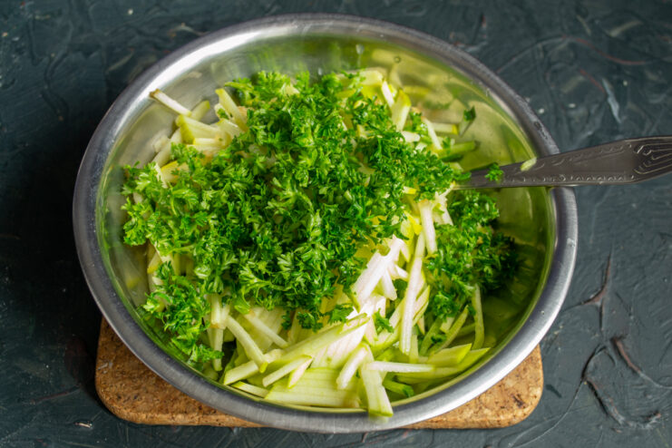 Finely chopped fresh curly parsley sprinkled over the salad ingredients