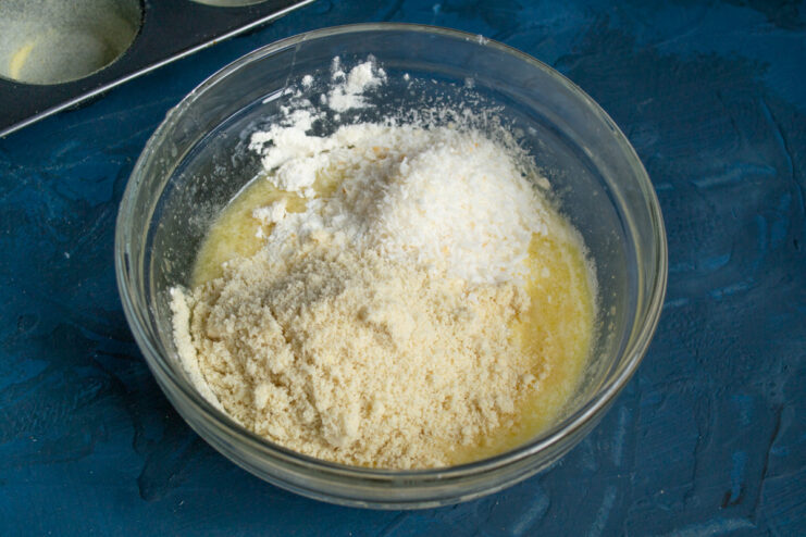 Adding dry ingredients Almond flour and desiccated coconut added to the wet mixture.