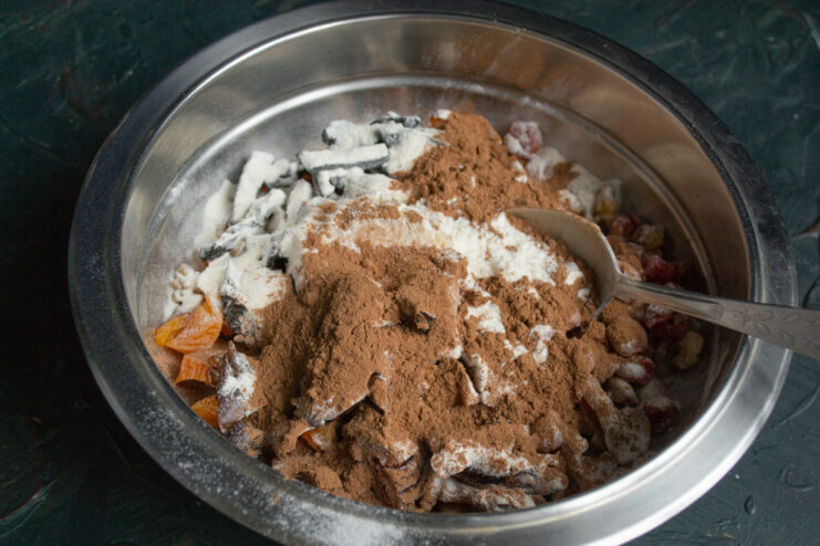 Dry ingredients Flour and cocoa powder mixed into the nuts and dried fruit