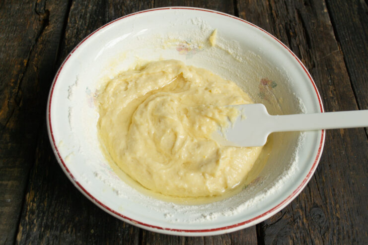 Adding oil to the batter Pouring vegetable oil into the lemon muffin batter