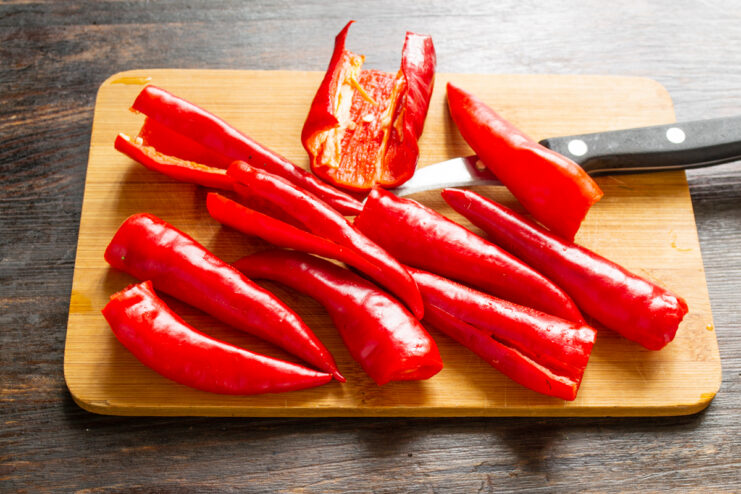Removing The Seeds Sliced red chili peppers without seeds on a cutting board