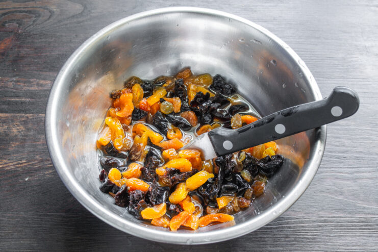 Prepping Dried Fruits Chopped dried fruits soaking in a bowl of apple juice