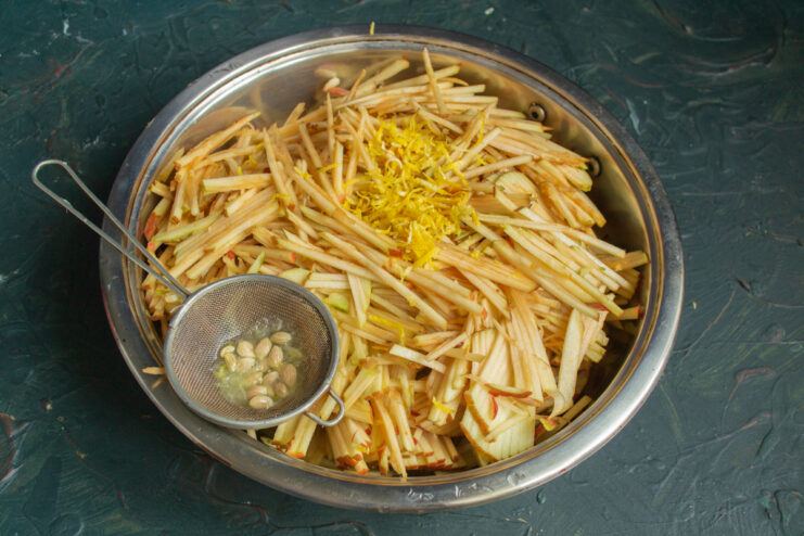 Preparing the apple filling Chopped apples mixed with lemon zest and juice in a bowl