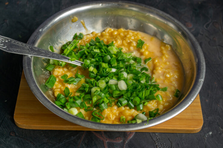 Adding green onions Chopped green onions folded into the rice filling.