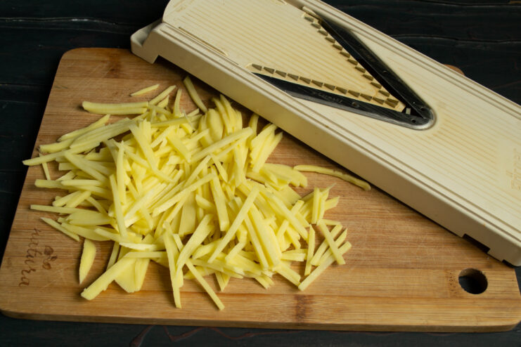 Prepping The Potatoes Julienning potatoes into thin strips for the salad