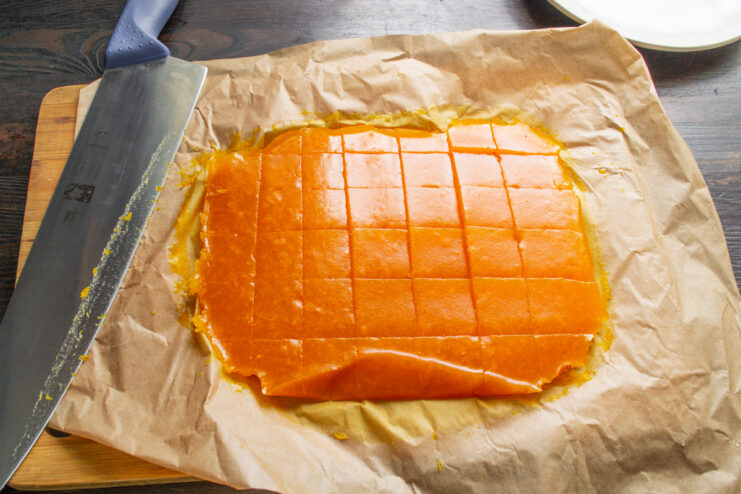 Slicing the Dessert Cutting the set apricot jelly into squares with a knife