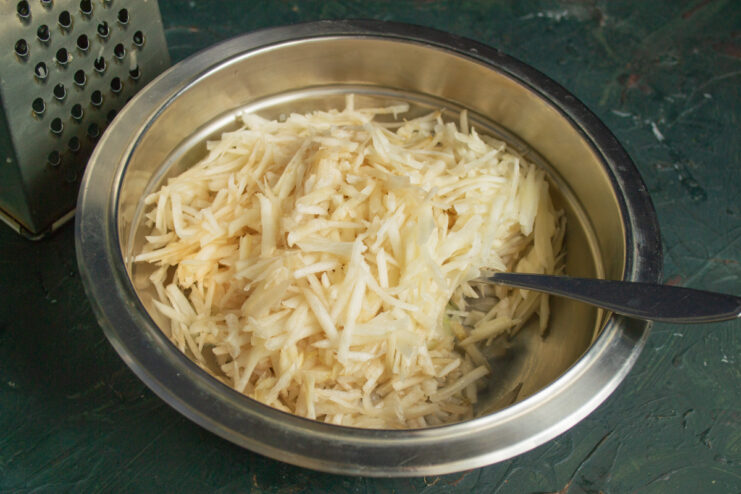 Grating the vegetables Freshly grated sunchokes mixed with sauteed onions