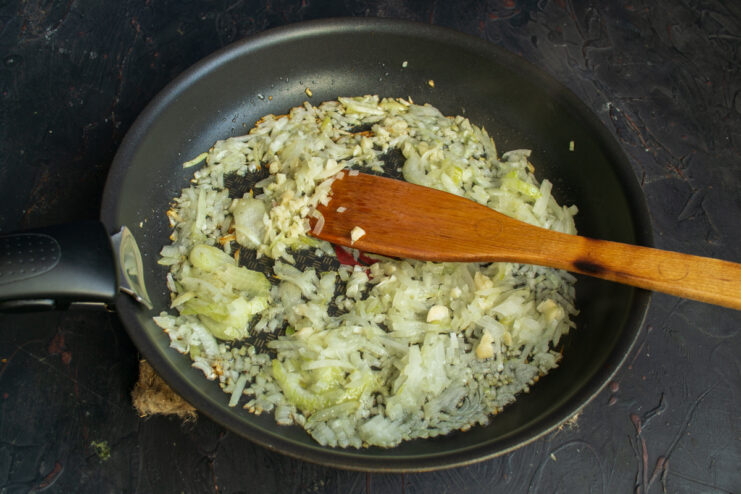 Sautéing onion and garlic Sautéing chopped onion and garlic in a skillet with olive oil