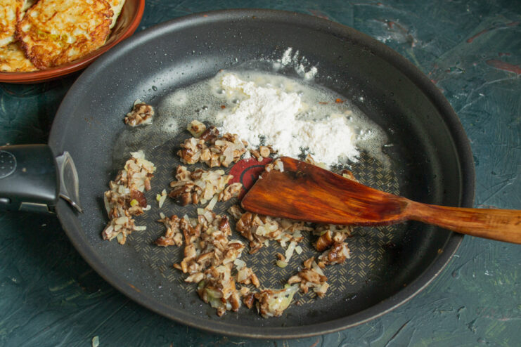 Building the sauce base Toasting flour with sauteed mushrooms and onions in a skillet