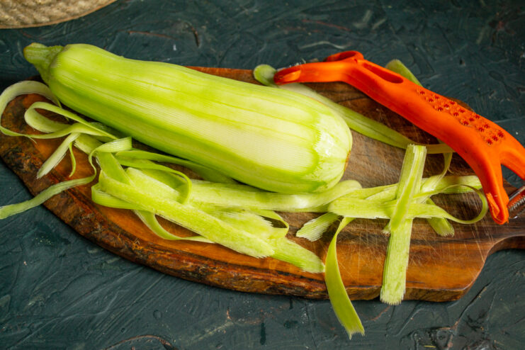 Preparing The Zucchini Peeling a green zucchini with a vegetable peeler
