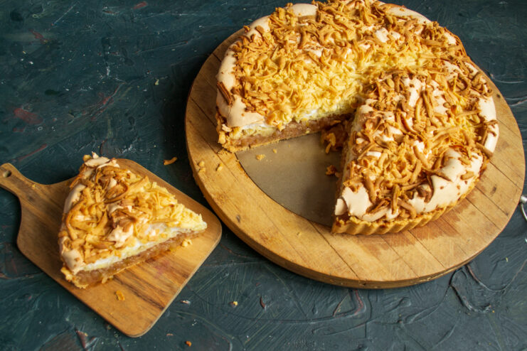 Serving the apple pie Sliced piece of layered Polish apple pie on a wooden cutting board