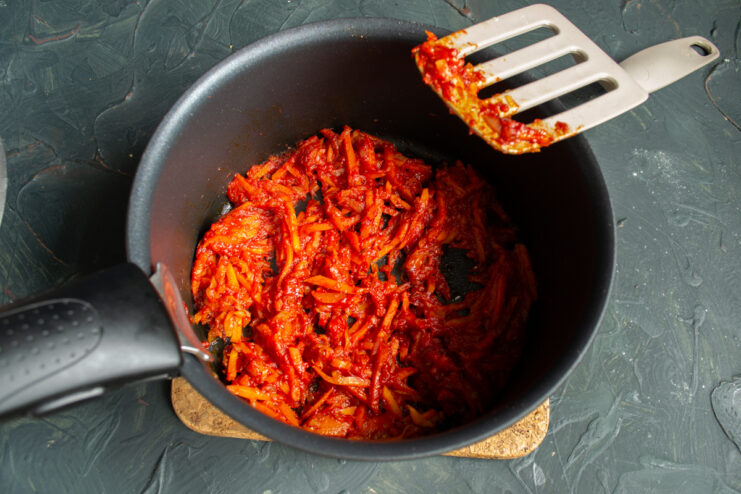 Simmering Vegetables with Spices Vegetable soup base mixed with tomato paste and red paprika.