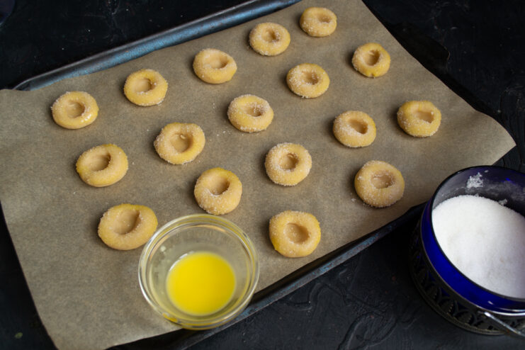Preparing for baking Cookies brushed with egg yolk and sprinkled with sugar before baking.