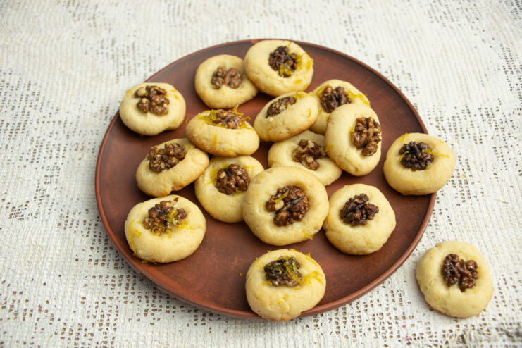 Finished dessert Walnut shortbread cookies garnished with lime zest on a plate