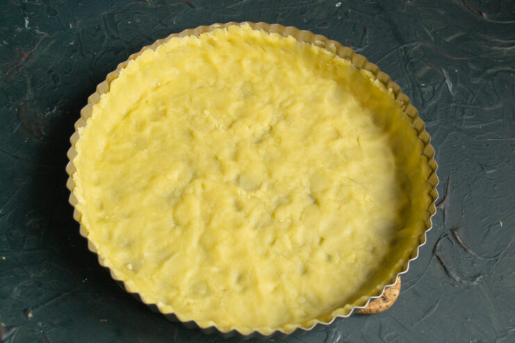Forming the pie crust Shortcrust pastry pressed evenly into the bottom and sides of a baking pan