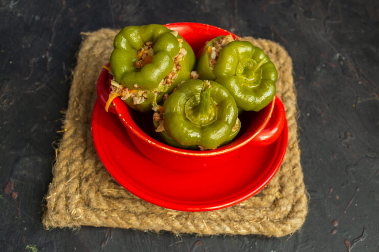 Serving the stuffed peppers Serving warm stuffed peppers in a red dish with soy sauce or vegan mayonnaise