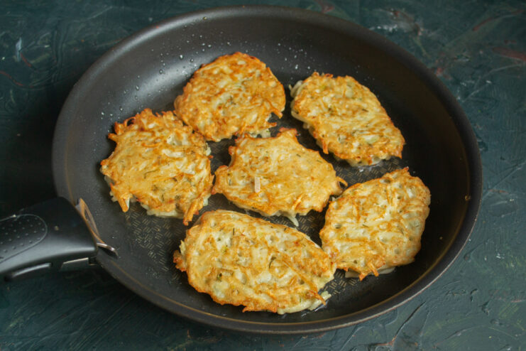 Achieving a golden crust Fritters flipped to reveal a golden-brown crust in a skillet