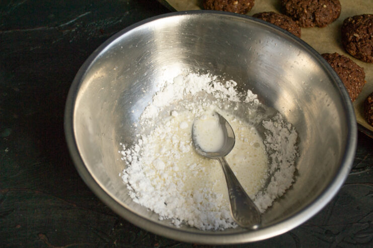 Making the Creamy Glaze Mixing powdered sugar and heavy cream into a white glaze in a bowl