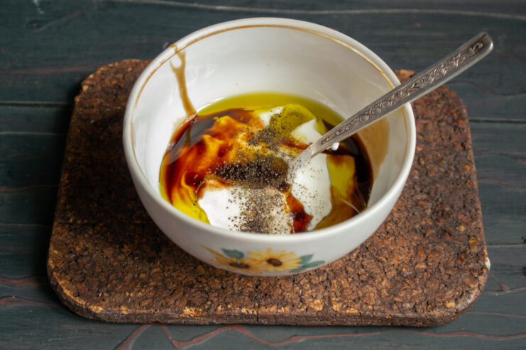 Making The Dressing Whisking sour cream dressing with soy sauce and spices