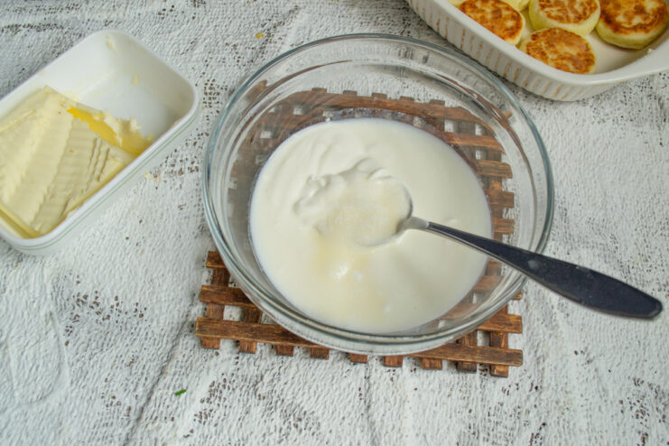 Whisking The Sauce Whisking sour cream, sugar, and heavy cream in a bowl