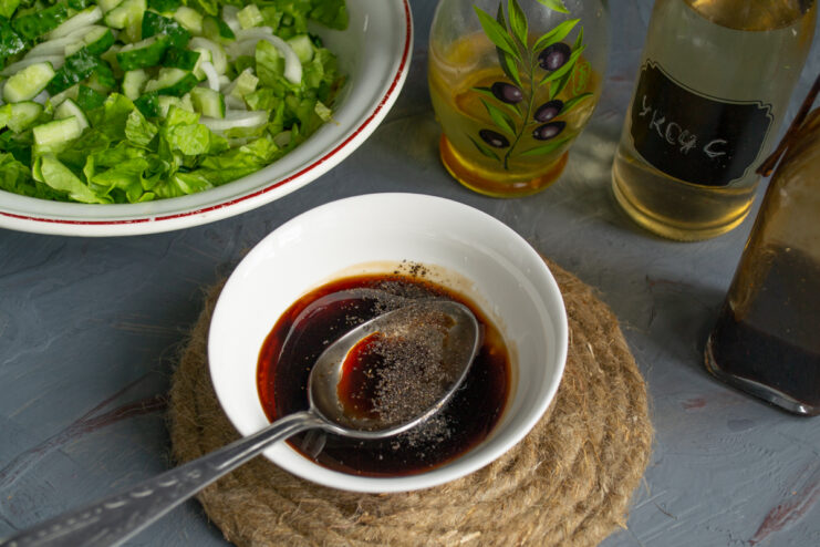 Making the Salad Dressing Preparing soy sauce dressing in a small white bowl