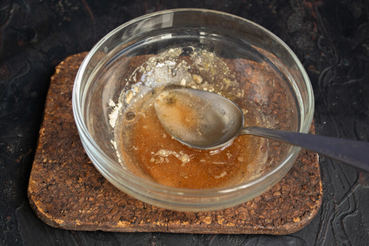 Making The Dressing Mixing vinegar, oil, and spices for salad dressing