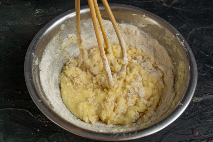 Mixing the shortbread dough Adding flour to the butter mixture to form cookie dough.
