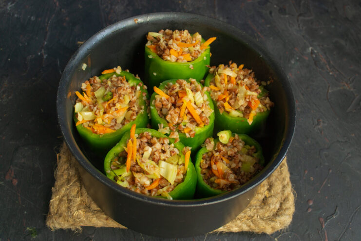 Stuffing the peppers Stuffing green bell peppers with the buckwheat and vegetable mixture