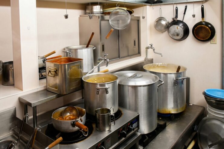 Ramen broth preparation Professional Japanese ramen kitchen showing large pots for boiling rich broth