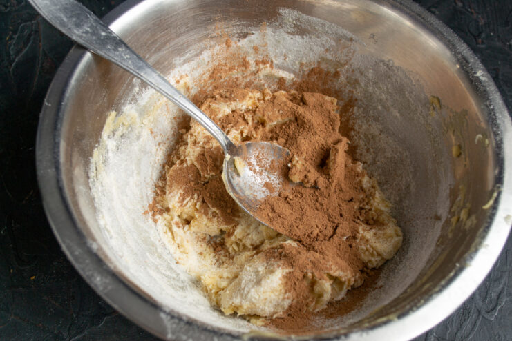 Sifting the Cocoa Sifting cocoa powder over the cookie dough mixture