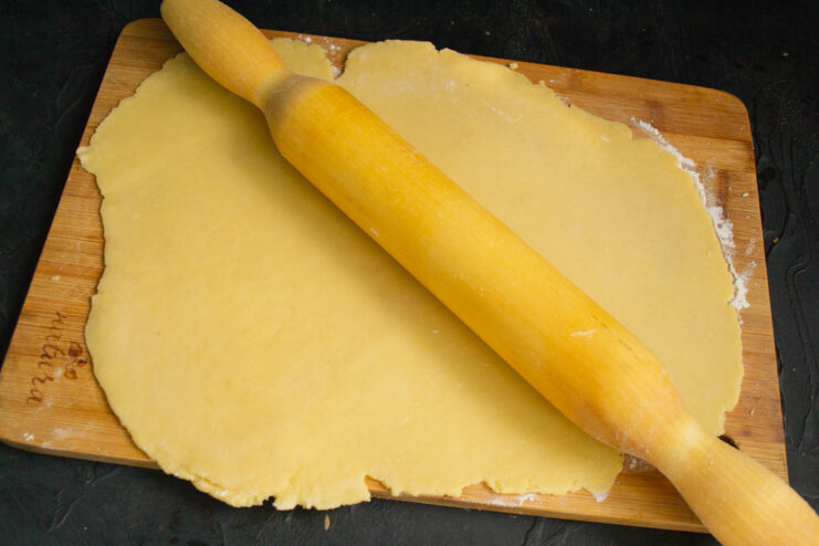 Rolling Out the Pastry Dough Rolled out shortcrust pastry with a rolling pin
