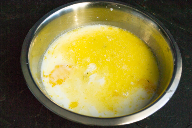Melted butter being added to the batter bowl.