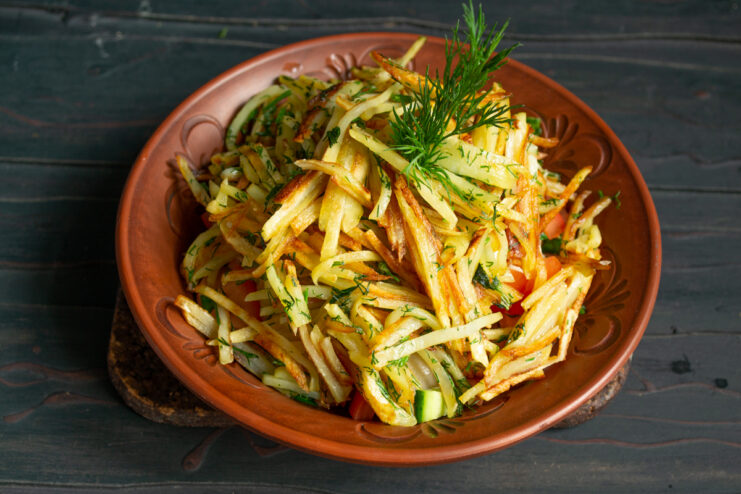 Final Assembly Anthill salad topped with a high mound of crispy fried potatoes